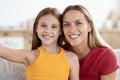 Cute daughter and mother funny beautiful smiling faces taking selfie