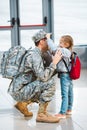 Cute daughter touching cap of father