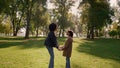 Cute daughter touching noses with lovely mother standing on field park closeup Royalty Free Stock Photo