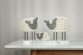 Cute decorative sheep and lamb figurine with phrase Dream Big Little One on white table against light background. Family Day