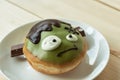 A cute delicious green doughnut in ghost face