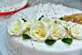 Cute delicious wedding cake decorated with cakes in the shape of red and white roses Royalty Free Stock Photo