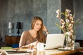Cute Designer Woman Sitting at Office and Using Laptop Royalty Free Stock Photo