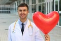 Cute doctor with a heart shaped balloon
