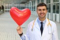 Cute doctor with a heart shaped balloon