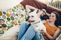 Cute dog smiling while on a trip with his owners, joyful young family, man and woman lying in comfortable hammock on a beach Royalty Free Stock Photo