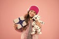 Cute dog toy quickly became her favourite friend. Happy child got toy gift pink background. Little girl cuddle soft toy Royalty Free Stock Photo