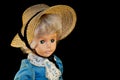 Cute doll that wears a hat and a blue dress Royalty Free Stock Photo