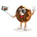 Cute donut mascot takes a selfie with smartphone