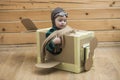 Brave dreamer boy playing with a cardboard airplane Royalty Free Stock Photo