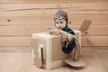 Cute dreamer boy playing with a cardboard airplane. Royalty Free Stock Photo