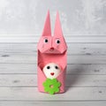 Cute Easter bunny egg holder. Rabbit made of paper using origami technique Royalty Free Stock Photo