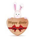 Cute Easter bunny holding a wooden heart with an inscription - Happy Easter Royalty Free Stock Photo