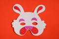 Cute Easter bunny mask on orange and vivid background