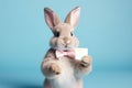 Cute Easter Bunny presenting a gift card - stock picture