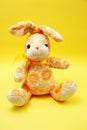 Cute easter bunny rabbit plush doll on yellow background