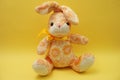 Cute Easter bunny rabbit plush doll Sitting on yellow background