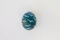 Cute Easter egg decorated by hand on a white table. Easter holiday concept. Beautiful egg speckled pink and blue Royalty Free Stock Photo