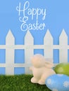 Cute Easter image with green grass, colorful sparkly eggs, a ceramic bunny and a white picket fence.