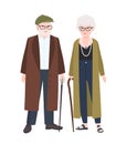 Cute elderly couple or grandparents. Pair of old man and woman with canes dressed in elegant outerwear walking together