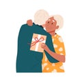 Cute elderly husband giving a gift box to wife on romantic date