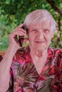 Cute, elderly woman talking on a mobile phone Royalty Free Stock Photo