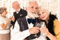 Elegant senior couple toasting with champagne during New Year`s Eve Royalty Free Stock Photo