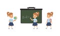 Cute Elementary School Students Studying at School, Adorable Girls Standing on front of Blackboard, Back to School Royalty Free Stock Photo