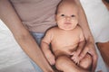 Cute emotional funny smiling newborn little baby infant boy sitting on mother hands. Healthy child Royalty Free Stock Photo