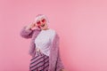 Cute emotional lady in pink short periwig fooling around in studio. Photo of happy european female