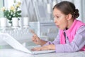 Close up portrait of cute little girl using modern laptop Royalty Free Stock Photo
