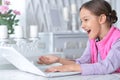 Portrait of cute little girl using modern laptop Royalty Free Stock Photo