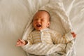 Cute emotional newborn little baby boy cry in crib. Royalty Free Stock Photo