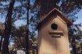 Cute empty wooden birdhouse in the park.