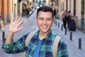 Cute ethnic guy saluting outdoors Royalty Free Stock Photo