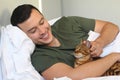 Cute ethnic man sleeping with his cat Royalty Free Stock Photo