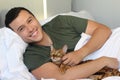 Cute ethnic man sleeping with his cat