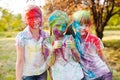 Cute european child girls celebrate Indian holi festival with colorful paint powder on faces and body