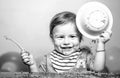 Cute excited funny baby with plate and spoon, babies eating. Kid boy eating healthy food. Royalty Free Stock Photo