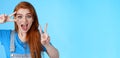 Cute excited redhead enthusiastic girl smiling, look joyful show peace, victory signs near face, optimistic lucky