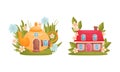 Cute fabulous cottages among summer flowers and grass set cartoon vector illustration