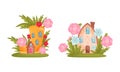 Cute fabulous houses among summer flowers and grass set. Little cottage of gnome or elf cartoon vector illustration Royalty Free Stock Photo