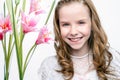 Cute face shot of communion girl with flowers.