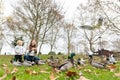 A cute family of a mother and her little son enjoying their walk in the park with pigeons and ducks flying around Royalty Free Stock Photo