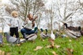 A cute family of a mother and her little son in the park surrounded by pigeons and ducks Royalty Free Stock Photo