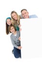 Cute family smiling at camera holding poster Royalty Free Stock Photo