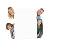 Cute family smiling at camera holding poster Royalty Free Stock Photo