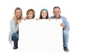 Cute family smiling at camera holding poster Royalty Free Stock Photo