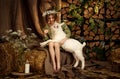 Cute farm girl hugs and feeds her little white goat Royalty Free Stock Photo