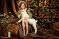 Cute farm girl hugs and feeds her little white goat Royalty Free Stock Photo